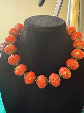 Mid century red coral colored lucite beads with goldtone filigree caps.